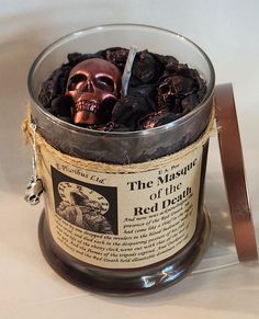 a glass jar filled with lots of chocolate chips and a skull on the front side