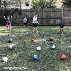 several children playing with different colored balls in the yard