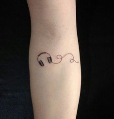 a woman's foot with headphones tattoo on the left side of her leg