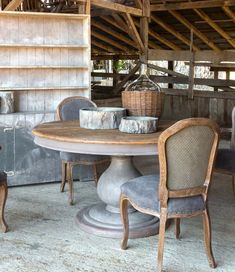 a table and chairs in an old barn