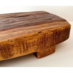 a close up of a wooden table on a white surface