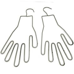 two pairs of metal wire hangers on a white background with clippings attached to them