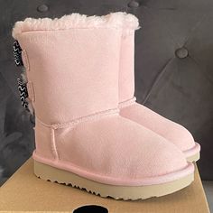 Ugg Bailey Bow Toddler Boots Pink Color Brand New & Comes With Original Box Multiple Sizes Available 7 Toddler And 8 Toddler 100% Autthentic, Bought From Ugg Store This Take On The Popular Bailey Bow Features An Artistic Squiggle-Striped Pattern For Playful Pop Of Color And Texture. It's Built For Kids On The Move With A Super-Lightweight Outsole For Traction And Durability. Responsibly Sourced Materials Include Recycled Polyester Binding And Uggpure Upcycled Wool Insole. Treadlite By Ugg Propri Black Glitter Boots, Toddler Uggs, Holiday Boots, Cute Stuff To Buy, Ugg Bailey Boots, Toddler Ugg Boots, Grey Uggs, Ugg Bailey Bow, Ugg Store