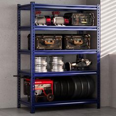 a blue shelving unit filled with different types of tires and other items on it