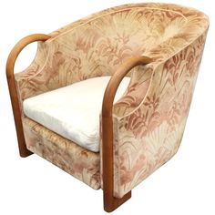 an upholstered chair with a white pillow on it's back and arms