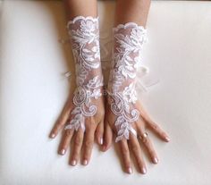 two hands with white lace on them