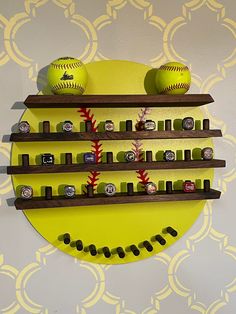 two baseballs are sitting on the shelves in front of a wall with other items