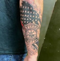 a man with a fire department tattoo on his arm