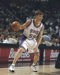 a basketball player dribbling the ball during a game