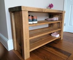 there is a wooden shelf with shoes on it