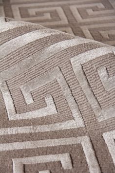 an area rug that has been placed on top of another piece of furniture with the same pattern as it appears in this photo