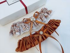 two garters are laying next to a gift box