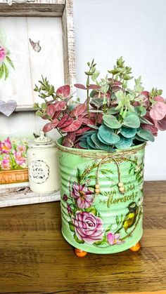 a potted plant sitting on top of a wooden table next to a framed picture