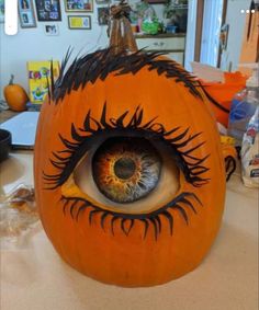 a pumpkin with an eye painted on it