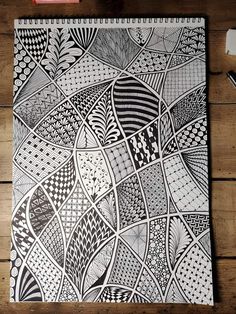 a black and white drawing on top of a wooden table