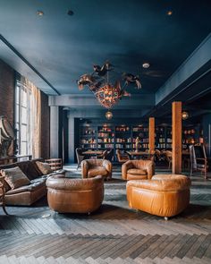 a living room filled with lots of brown furniture