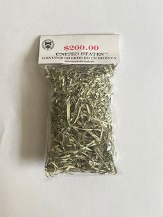 a bag of green shredded grass sitting on top of a white table