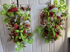 two christmas wreaths hanging on the front door