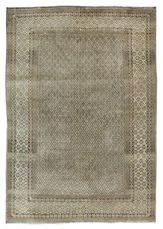 an old rug with squares and dots on the bottom, in grey tones is shown