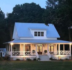 a white house with porches and lights on