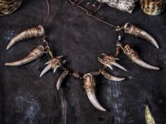 the necklace is adorned with various animal's horns