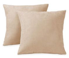 two beige pillows sitting next to each other