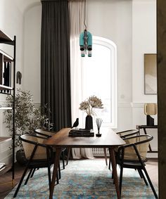 a dining room table and chairs in front of a window