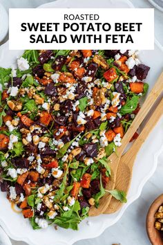 roasted sweet potato beet salad with feta in a white bowl and wooden spoon