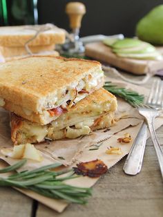 a grilled cheese sandwich sitting on top of a wooden table