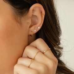 Say hello to your new favorite earring pairs with the Signature Earrings Set #2! You'll love how versatile these earrings are. Whether it's the Dainty CZ Stud Earrings, the Triple CZ Stud Earrings, or Huggie Hoop Earrings, any pair you pick will add a beautiful shine to your outfit. They're lightweight yet durable, so you can wear them all day - and every day! DETAILS Set includes three pairs of earrings: Huggie Hoop Earrings 14k gold vermeil -or- sterling silver huggie hoops 12mm diameter; 2mm 4 Hole Ear Piercing Earrings, 3 Earring Set, Ear Piercings 3 Holes, Triple Piercing Earrings, Love Knot Ring, Solid Gold Bracelet, Piercing Earrings, Diamond Jewelry Necklace, Solid Gold Necklace