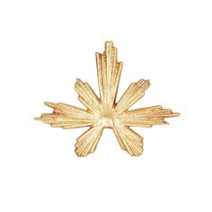 a gold plated metal snowflake on a white background