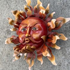 a red sun with a man's face painted on it