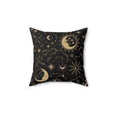 a black pillow with gold stars and the moon in the sky on top of it