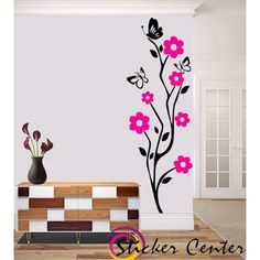 wall decals with flowers and butterflies in the corner, on a white room floor