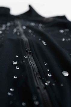 rain drops on the zipper of a black jacket