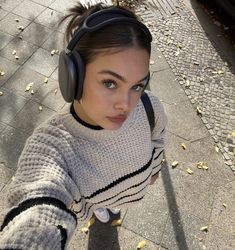 a woman wearing headphones on the street