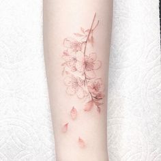 a woman's arm with flowers on it