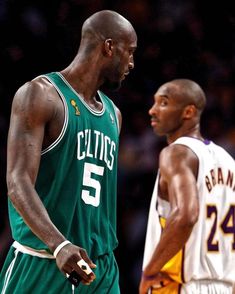 two basketball players standing next to each other