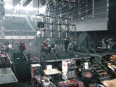 a group of people standing on top of a stage in front of microphones and sound equipment