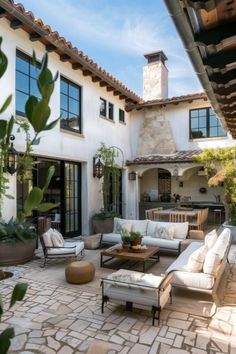 an outdoor living area with couches and tables