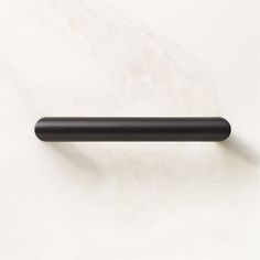 a black handle on a white marble surface