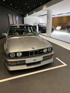 a silver car parked in a garage next to other cars