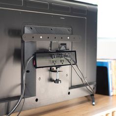 a flat screen tv sitting on top of a wooden table