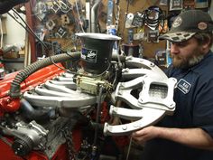 a man working on an engine in a shop