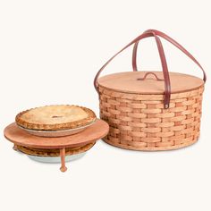 a basket with a pie in it and another one on the plate next to it