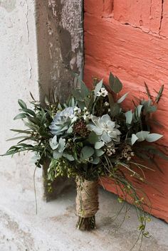 a bouquet of flowers sitting on the side of a door