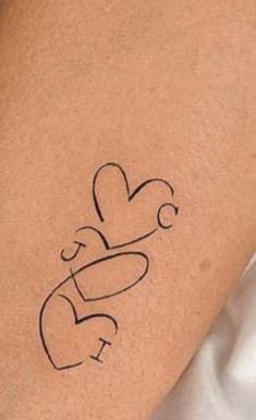 a woman's arm with a tattoo on it that says love and is in the shape of a heart