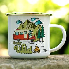 a camper mug sitting on top of a wooden table