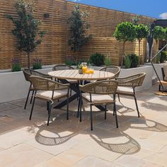 an outdoor table and chairs on a patio