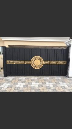 a black and gold garage door in front of a house